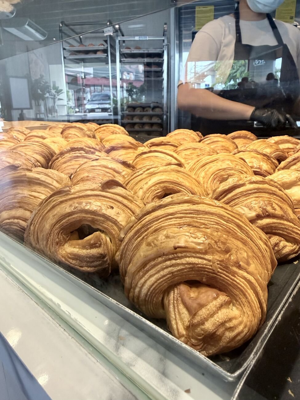 Croissants close up. The lamination — those fine layers — is the tell of a properly made bake.