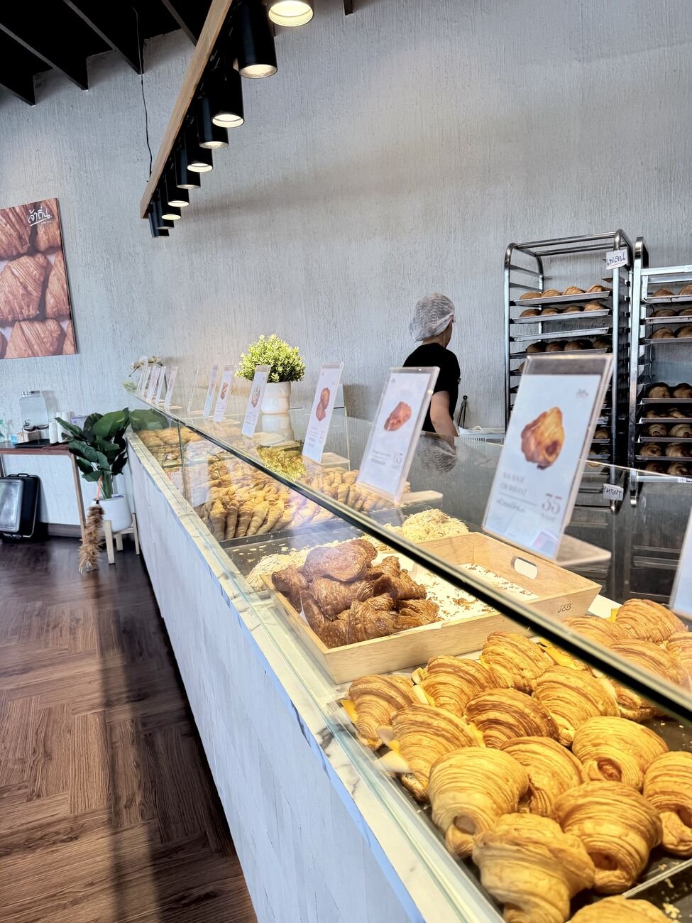 The display case, with printed price cards for each bake.
