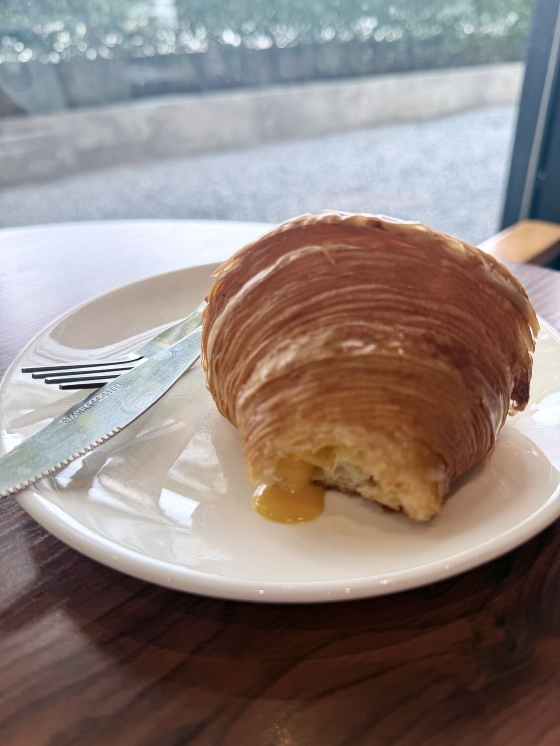 Chao-Thin salted egg lava croissant, broken open with the yolk lava running out