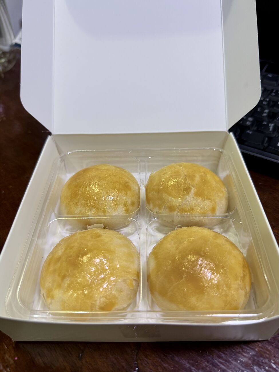 A box of four. The thin, layered skin gives way to the salted-egg lava centre.
